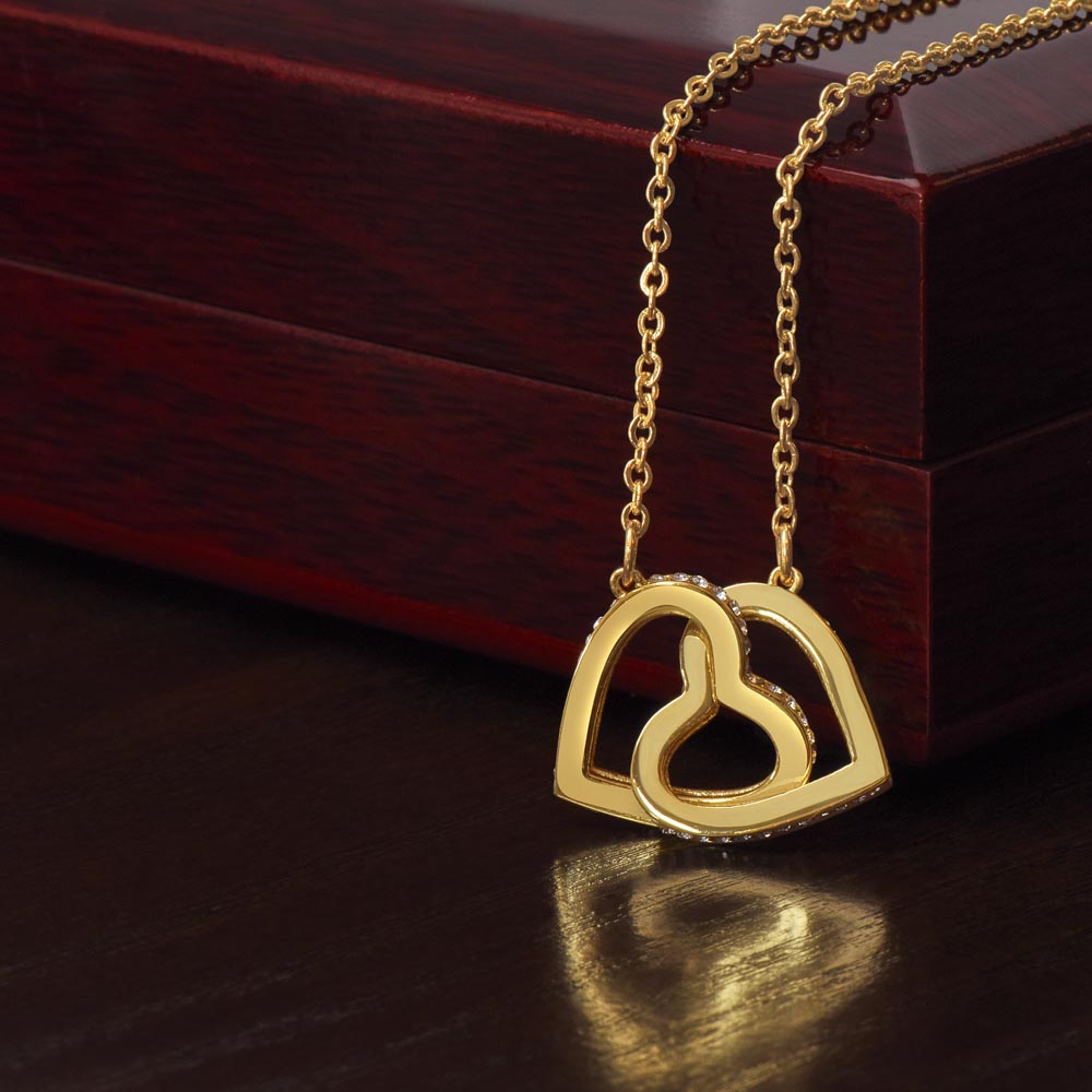 “Interlocking hearts necklace in silver and rose gold displayed in gift box with romantic ‘To My Girlfriend’ message card from boyfriend.”
