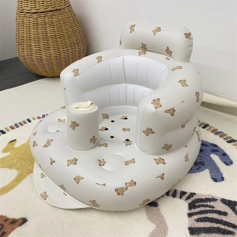 “Inflatable baby chair with supportive backrest and center post, featuring pink bunny pattern, designed for safe seating during dining or bath time.”