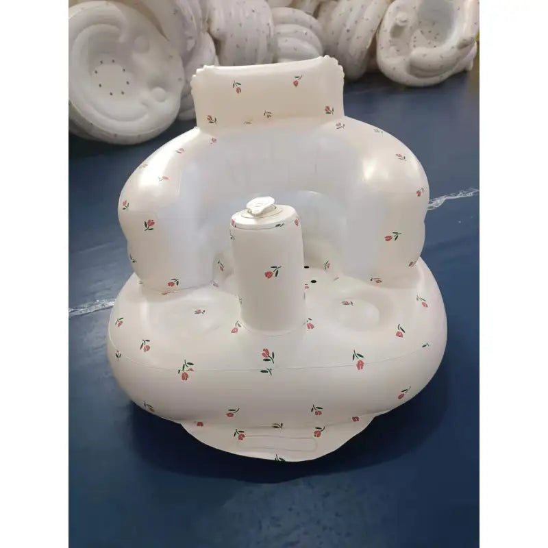 “Inflatable baby chair with supportive backrest and center post, featuring pink bunny pattern, designed for safe seating during dining or bath time.”
