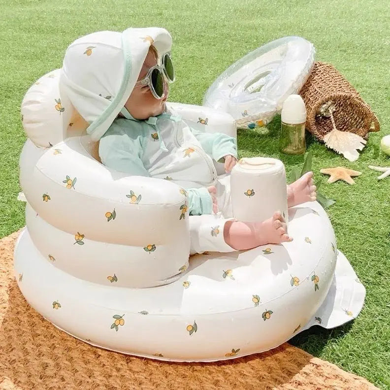 “Inflatable baby chair with supportive backrest and center post, featuring pink bunny pattern, designed for safe seating during dining or bath time.”