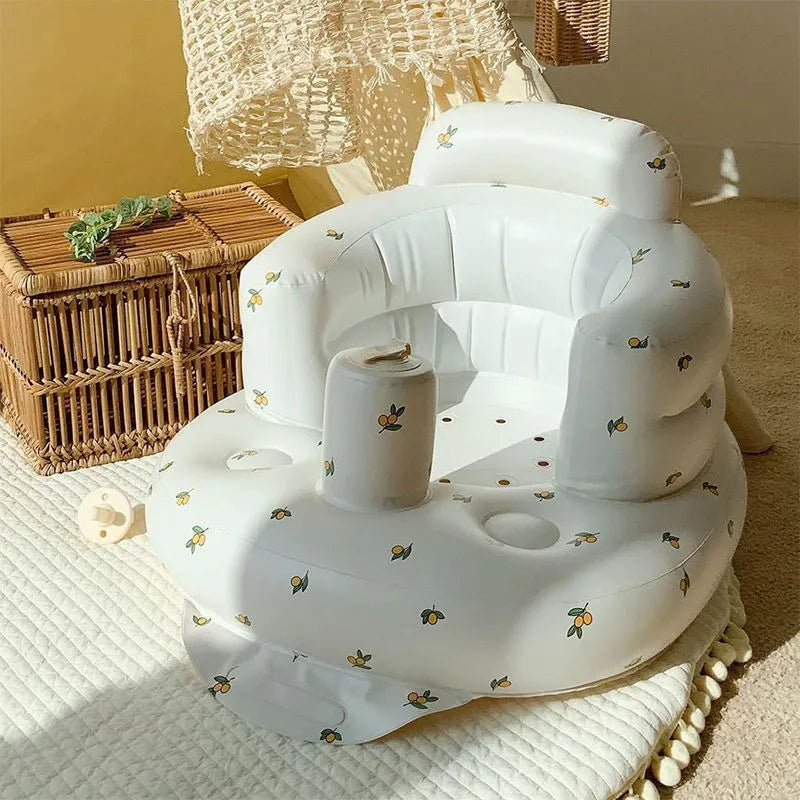 “Inflatable baby chair with supportive backrest and center post, featuring pink bunny pattern, designed for safe seating during dining or bath time.”