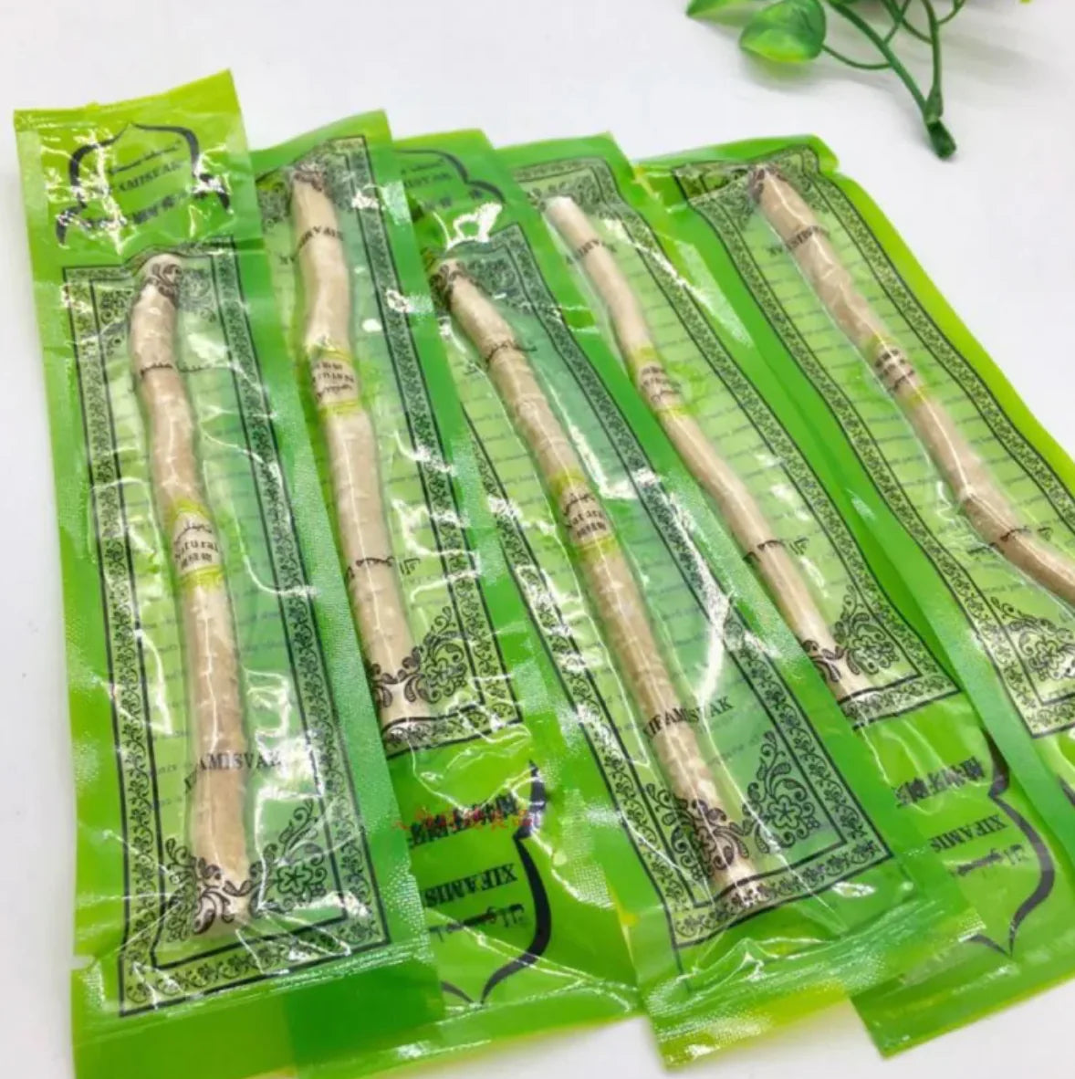 “Natural miswak tooth‑cleaning stick used for traditional oral hygiene, thin 15cm wood branch with frayed brushing tip.”
