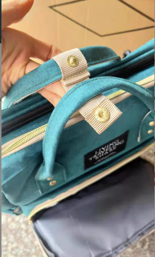 “Large‑capacity mommy backpack with front zipper pocket, dual top handles, and adjustable shoulder straps, designed for organized baby essentials and travel use.”