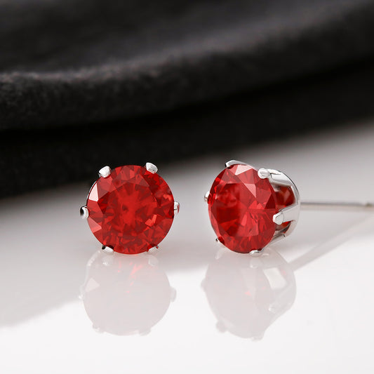 “Round red cubic zirconia stud earrings in rhodium‑plated stainless‑steel prong setting, 6mm stones with post backing.”