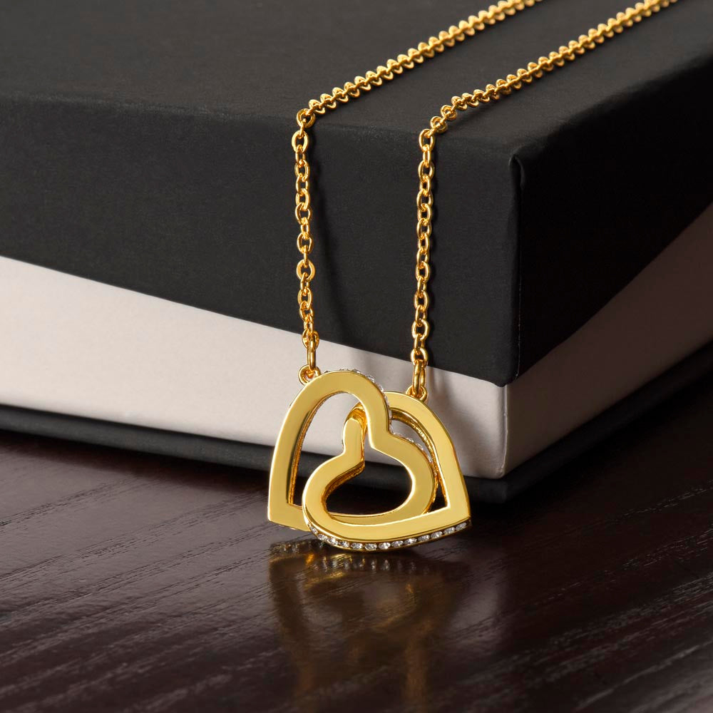 “Interlocking hearts necklace in silver and rose gold displayed in gift box with romantic ‘To My Girlfriend’ message card from boyfriend.”