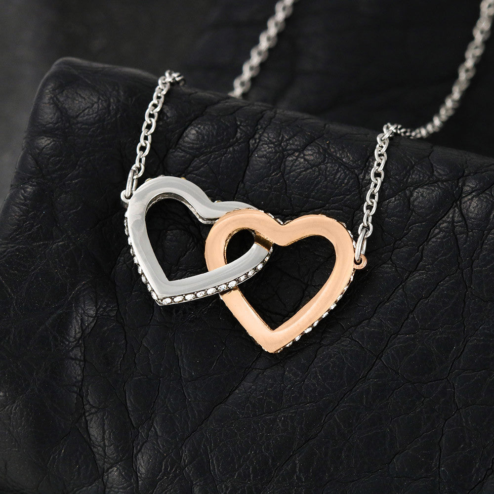 “Interlocking hearts necklace in silver and rose gold displayed in gift box with romantic ‘To My Girlfriend’ message card from boyfriend.”