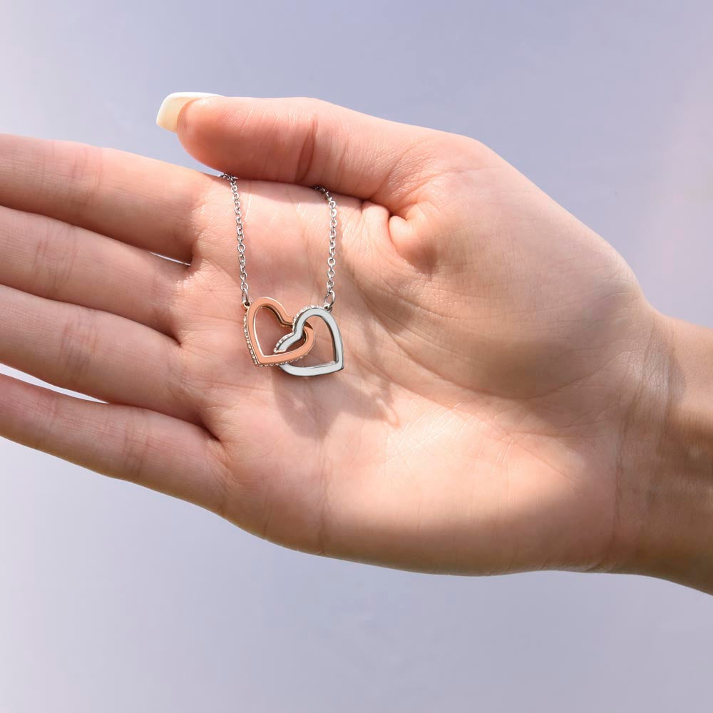 “Interlocking hearts necklace in silver and rose gold displayed in gift box with romantic ‘To My Girlfriend’ message card from boyfriend.”
