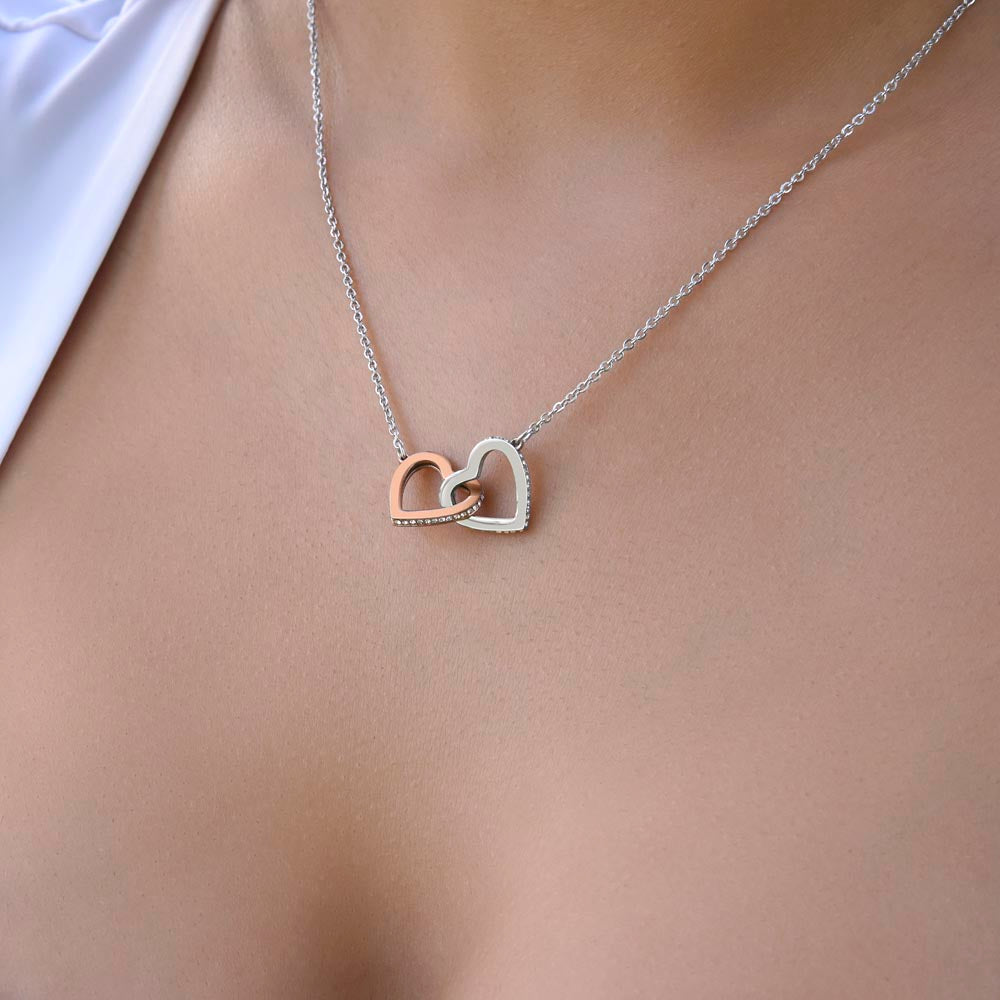 “Interlocking hearts necklace in silver and rose gold displayed in gift box with romantic ‘To My Girlfriend’ message card from boyfriend.”