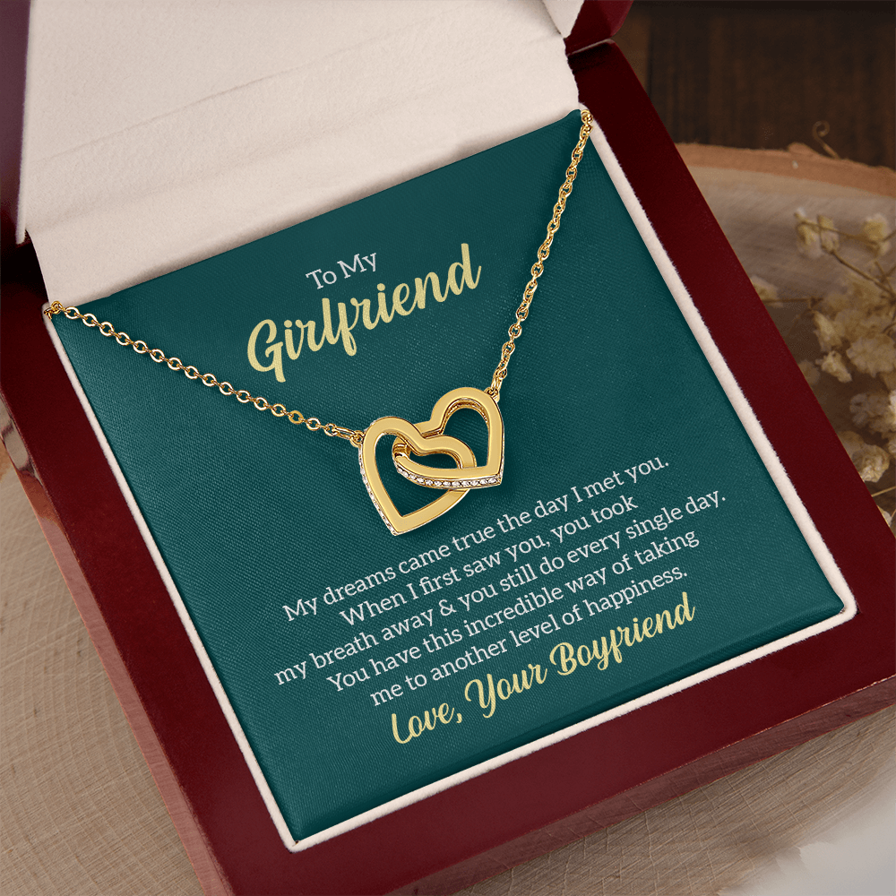 “Interlocking hearts necklace in silver and rose gold displayed in gift box with romantic ‘To My Girlfriend’ message card from boyfriend.”