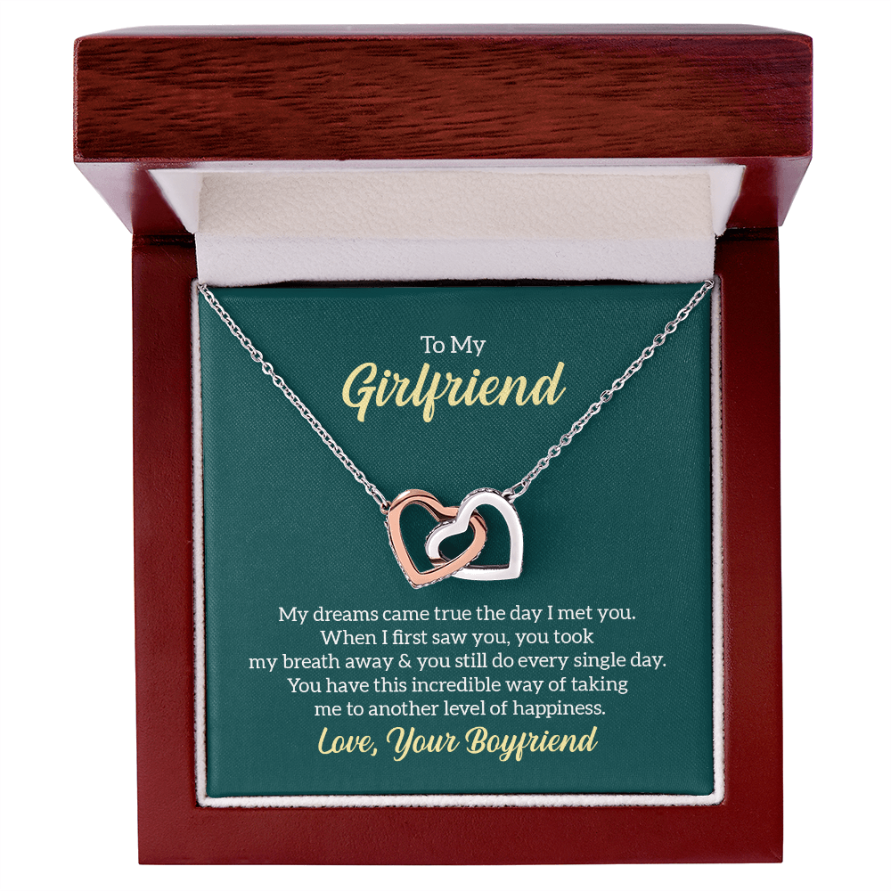 “Interlocking hearts necklace in silver and rose gold displayed in gift box with romantic ‘To My Girlfriend’ message card from boyfriend.”