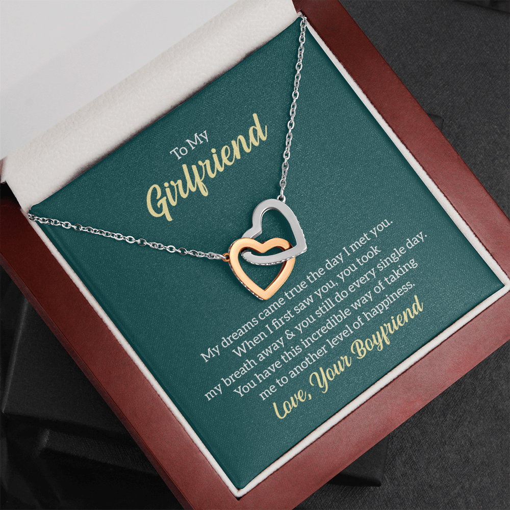 “Interlocking hearts necklace in silver and rose gold displayed in gift box with romantic ‘To My Girlfriend’ message card from boyfriend.”