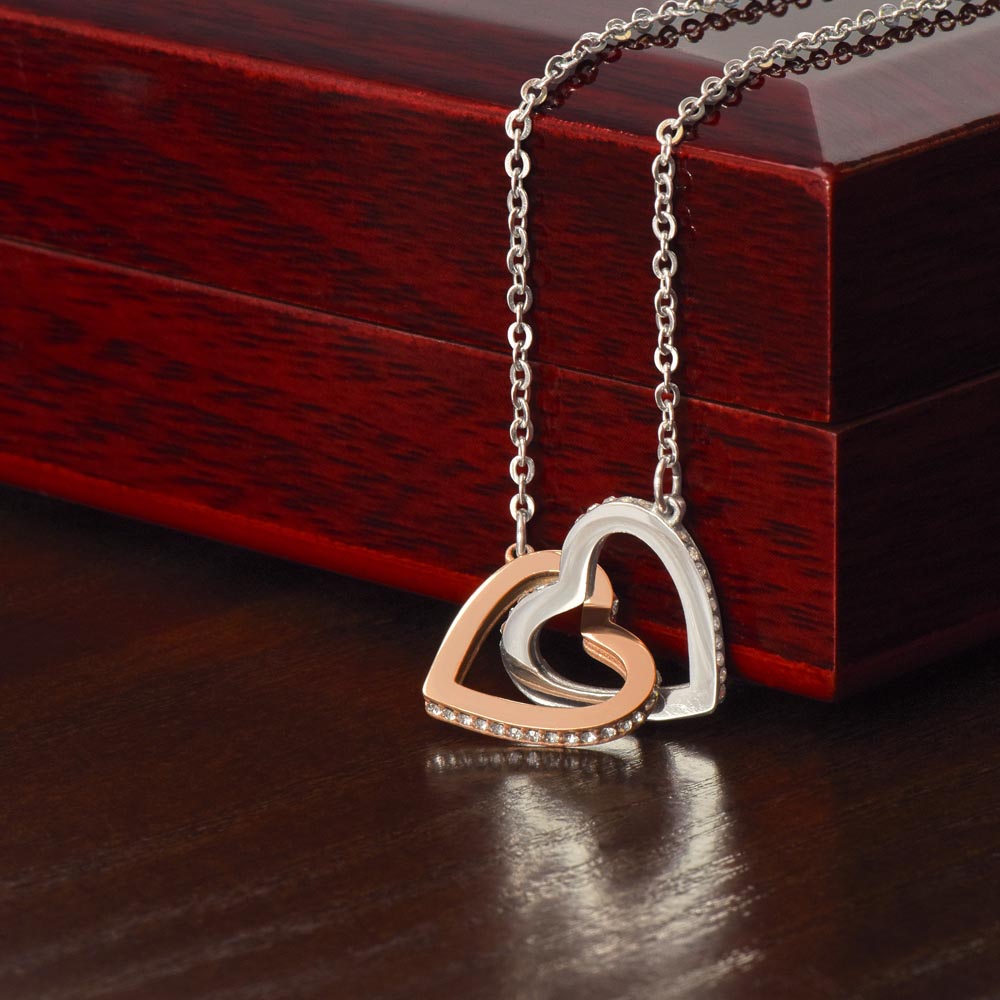 “Interlocking hearts necklace in silver and rose gold displayed in gift box with romantic ‘To My Girlfriend’ message card from boyfriend.”