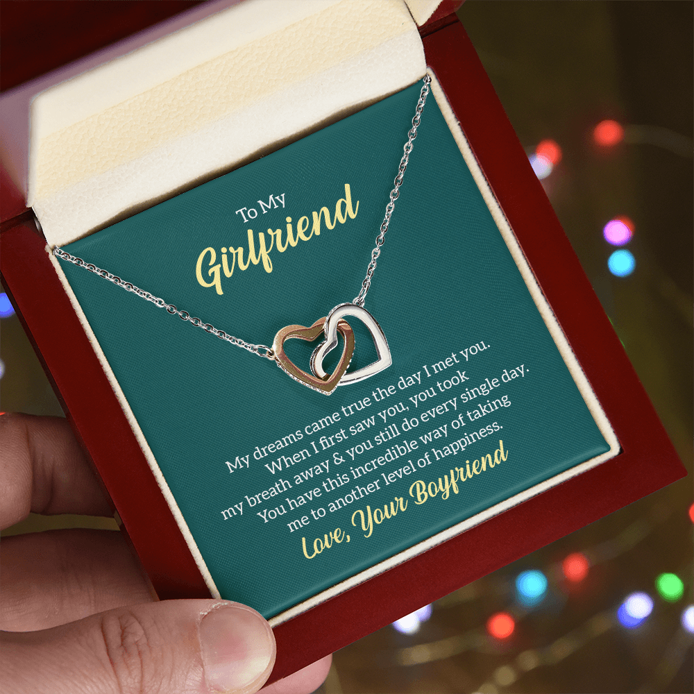 “Interlocking hearts necklace in silver and rose gold displayed in gift box with romantic ‘To My Girlfriend’ message card from boyfriend.”