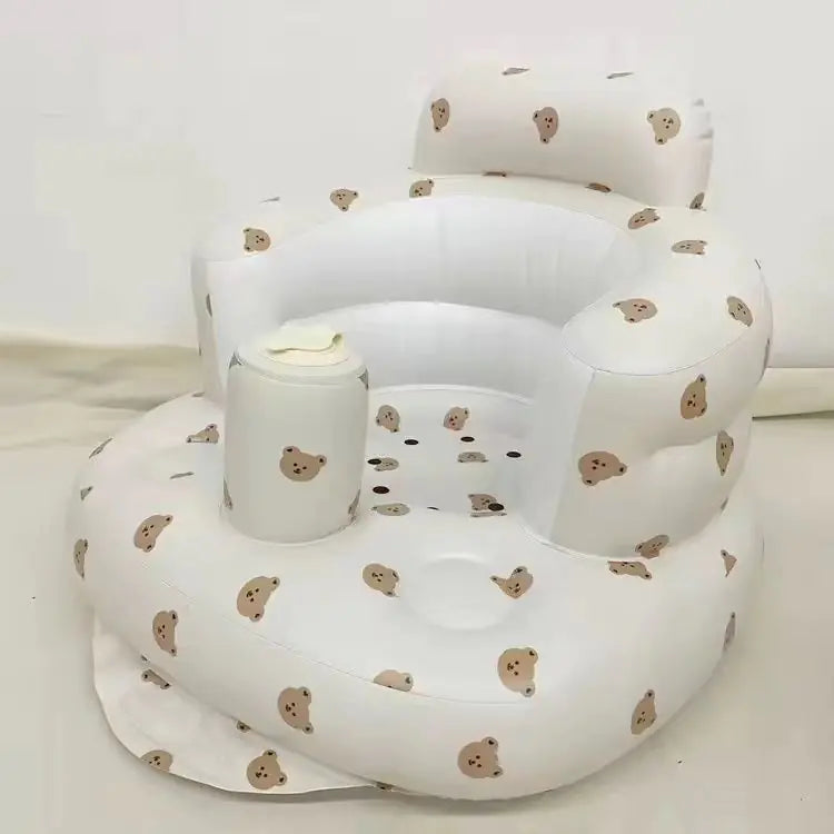 “Inflatable baby chair with supportive backrest and center post, featuring pink bunny pattern, designed for safe seating during dining or bath time.”