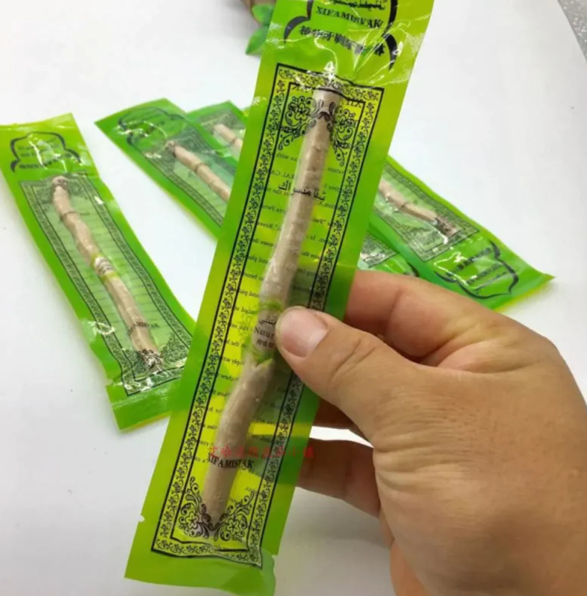 “Natural miswak tooth‑cleaning stick used for traditional oral hygiene, thin 15cm wood branch with frayed brushing tip.”