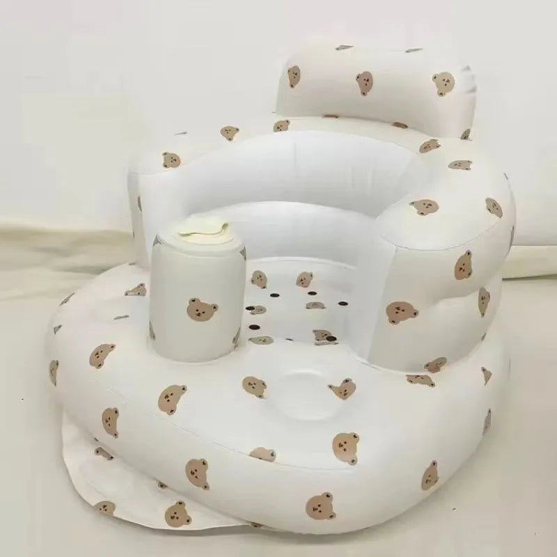 “Inflatable baby chair with supportive backrest and center post, featuring pink bunny pattern, designed for safe seating during dining or bath time.”