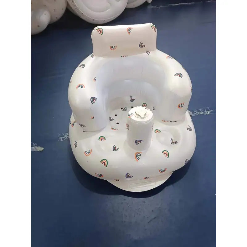 “Inflatable baby chair with supportive backrest and center post, featuring pink bunny pattern, designed for safe seating during dining or bath time.”
